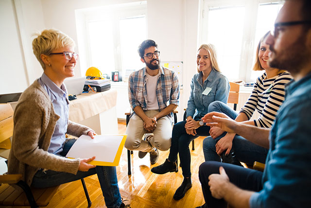 A small, happy group of people sitting in chairs