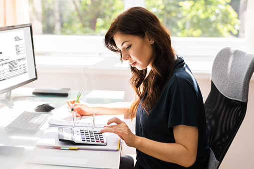 Accountant using e-invoice software at a computer