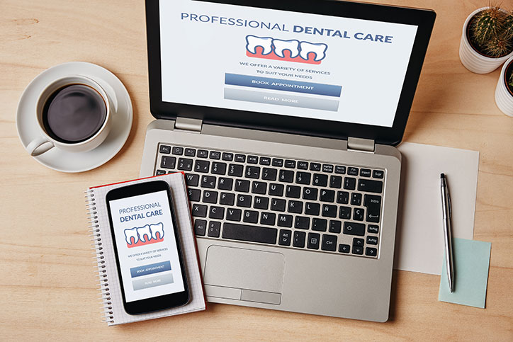 Laptop and mobile phone showing a dental website