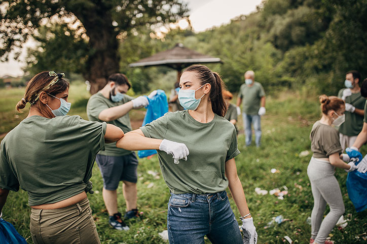 Volunteers safely cleaning up trash